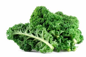 Some kale leaves on a white background.