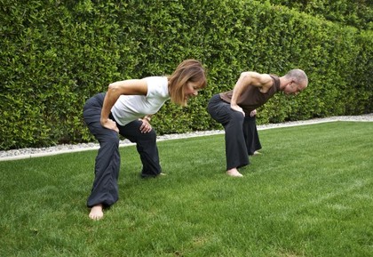 A man and woman performing tabletop.