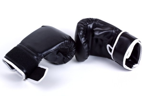 A pair of black boxing gloves on a white background.