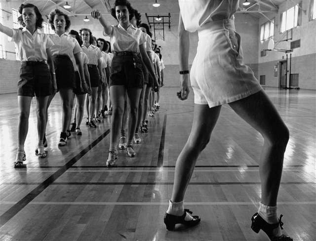 A group of women dancing  in a studio.
