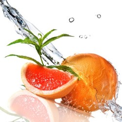 A chopped and whole grapefruit being splashed with water.