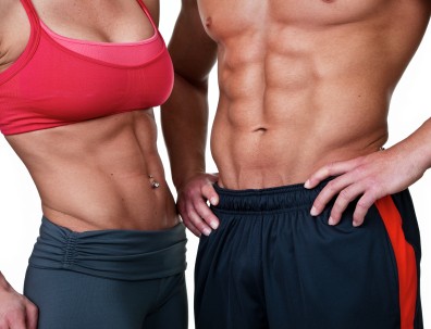 A close up shot of a couple with toned abdominal muscles.