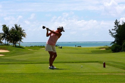 A woman playing golf.