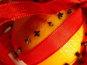 A Christmas orange wrapped in a red ribbon.