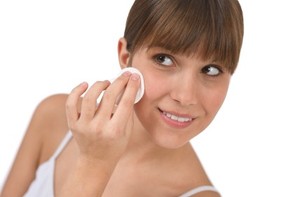 A woman wiping her face.