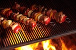 Kebabs being grilled on a barbecue.