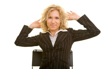 A business woman exercising in her office chair.