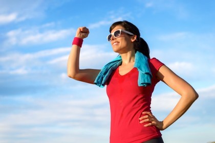 A happy woman flexing.