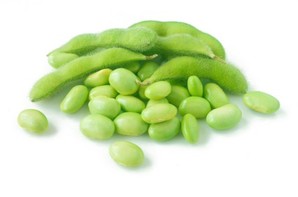 A group of soybeans and soybean pods.