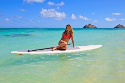 A girl in a bikini on a paddleboard.