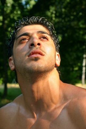 Muscular man looking upwards