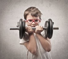 A skinny boy curling a dumbbell.