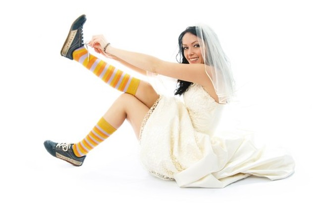 A bride wearing sports shoes.