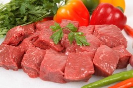 Cubes of raw beef with bell peppers.