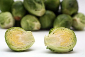 A selection of Brussels sprouts on a white background.