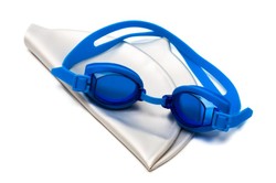 A pair of blue goggles on top of a white swim cap.