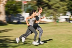 A couple jogging in the park.