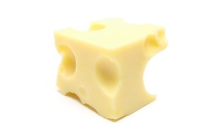 A block of swiss cheese on a white background.