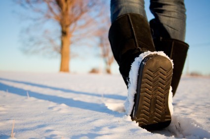 A close up shot of a person walking in winter.