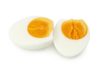 A cooked egg chopped in half.