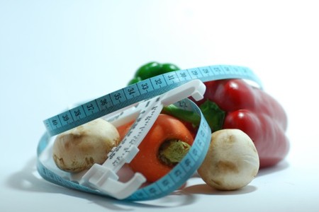 Vegetables wrapped in measuring tape