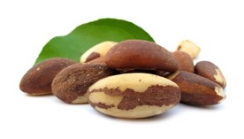 Brazil nuts with a leaf in the background.