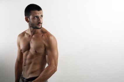 A shirtless man showing off his toned abs.