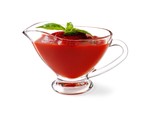 A glass jug containing tomato ketchup.