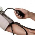 A person measuring their blood pressure.
