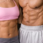 A couple showing off their toned stomach muscles.
