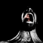 A man screaming in anger on a black background.
