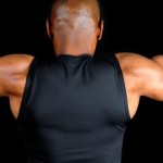 A close up shot of a man performing a chinup.