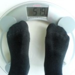A person standing on some weighing scales.