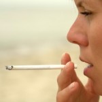 A close up shot of a woman smoking a cigarette.