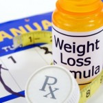 A pile of weight loss pills on a calendar.