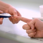 A person getting their blood glucose levels tested.