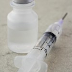 A bottle of insulin and a syringe.