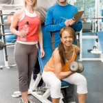 A man and woman lifting weights together.
