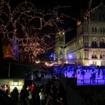 A group of people ice skating at night.