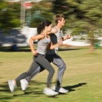 A couple jogging in the park.
