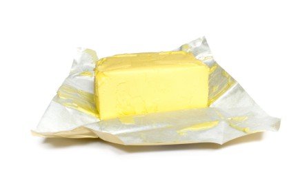 A block of butter on its foil wrapper.