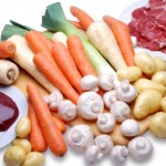 Raw meat and vegetables on a white background.
