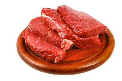 Raw fillet steak on a wooden plate.