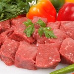 Cubes of beef with two bell peppers.