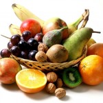 A basket containing a selection of fruit and nuts.