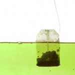 A green tea bag being brewed.