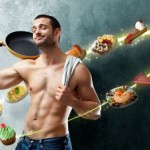 A man with toned abs and a frying pan surrounded by food.