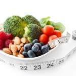 A selection of natural flavonoid rich foods wrapped in a tape measure.