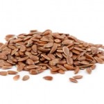 A pile of flaxseeds on a white background.
