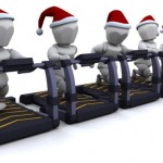 Silver figures in Christmas hats running on treadmills.
